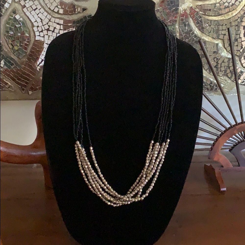 Long beaded black and silver tone necklace